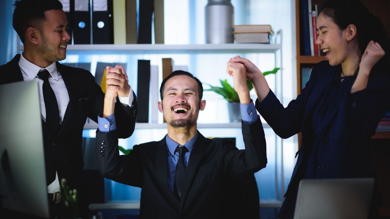 happy man celebrating with two people